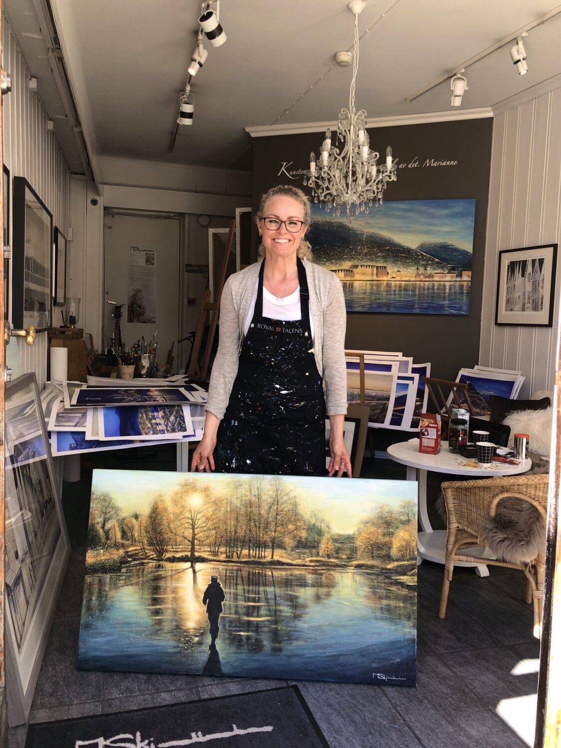 Marianne Skjelbred in her gallery in Bergen, with the painting Walking Towards the Light
